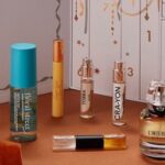 Fragrances from the Boots 12 Days of Scent Advent Calendar 2026 lined up in front of the open calendar, including Givenchy L Interdit and a NEOM candle