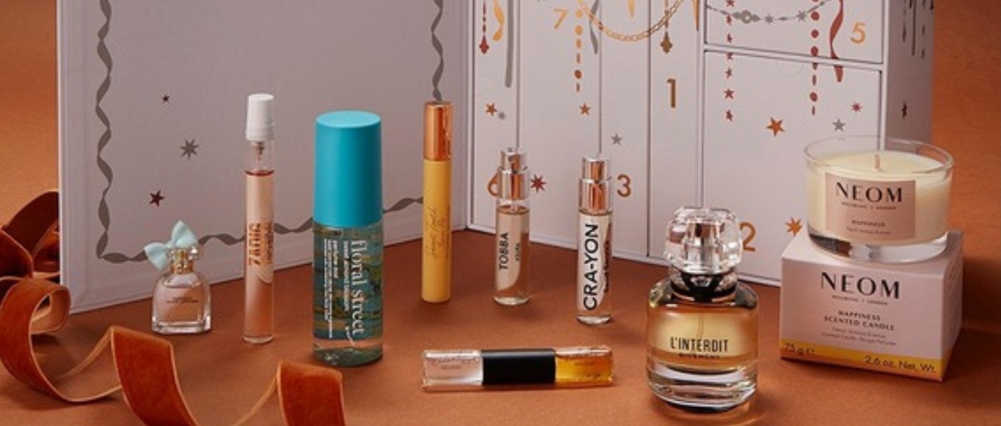 Fragrances from the Boots 12 Days of Scent Advent Calendar 2026 lined up in front of the open calendar, including Givenchy L Interdit and a NEOM candle