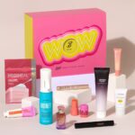 The pink Boots Trending Beauty Box with its ten products arranged in front, including Color Wow Money Mist, a Kayali perfume and a MILK Makeup jelly tint