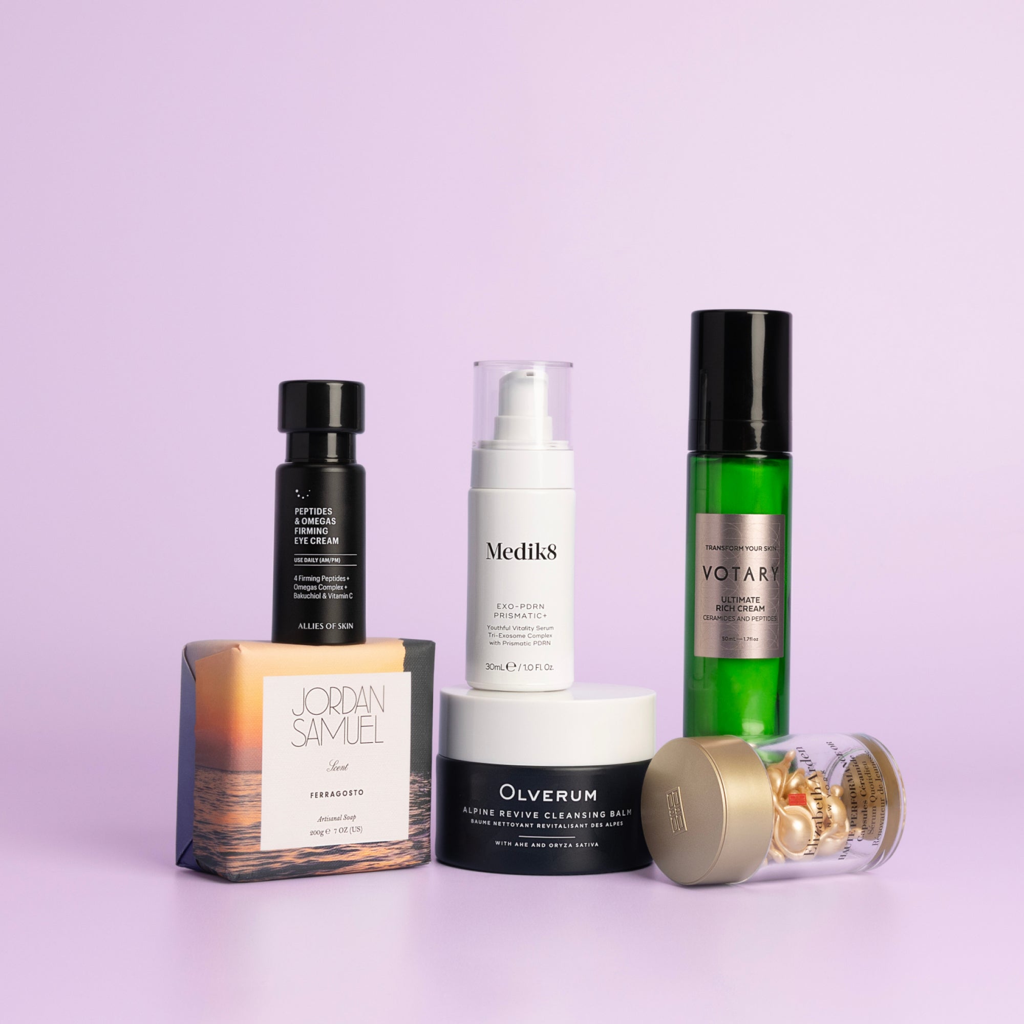 The six products in the Caroline Hirons Collagen Support Kit: Olverum Alpine Revive Cleansing Balm, Allies of Skin eye cream, Medik8 Exo-PDRN Prismatic+ Face Serum, Votary Ultimate Rich Cream, Elizabeth Arden Advanced Gold Ceramide Capsules and the Jordan Samuel Ferragosto Artisanal Soap