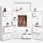 The Dior La Malle des Rêves advent calendar 2026 opened out as a white dressing table, its drawers holding Collection Privée perfumes, a candle and a snow globe, with a gingerbread-style gown scene at its centre