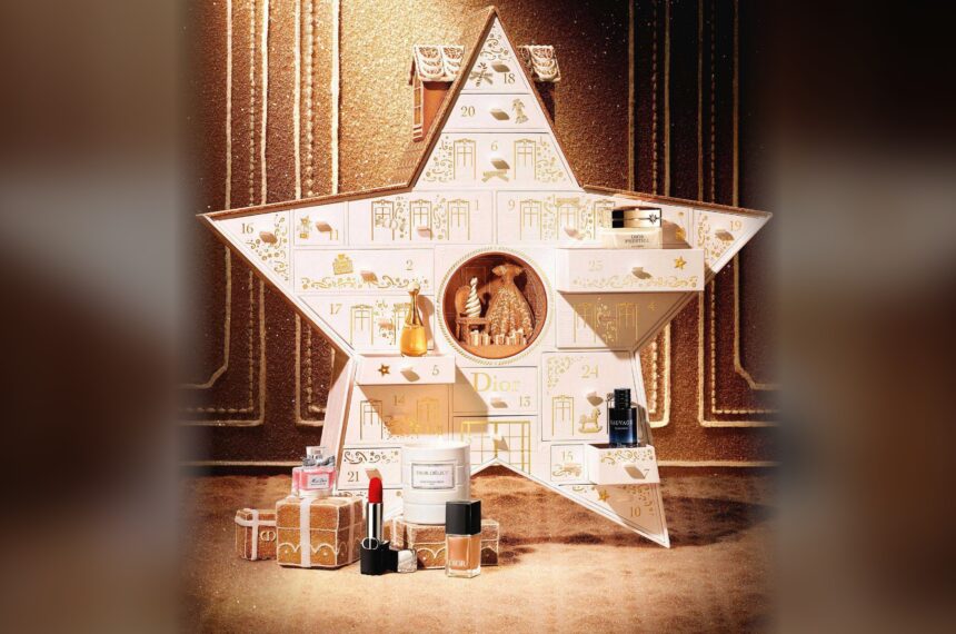 The Dior Le 30 Montaigne advent calendar 2026 open, a white star with numbered doors, with Dior lipstick, perfumes, nail polish and a candle arranged in front