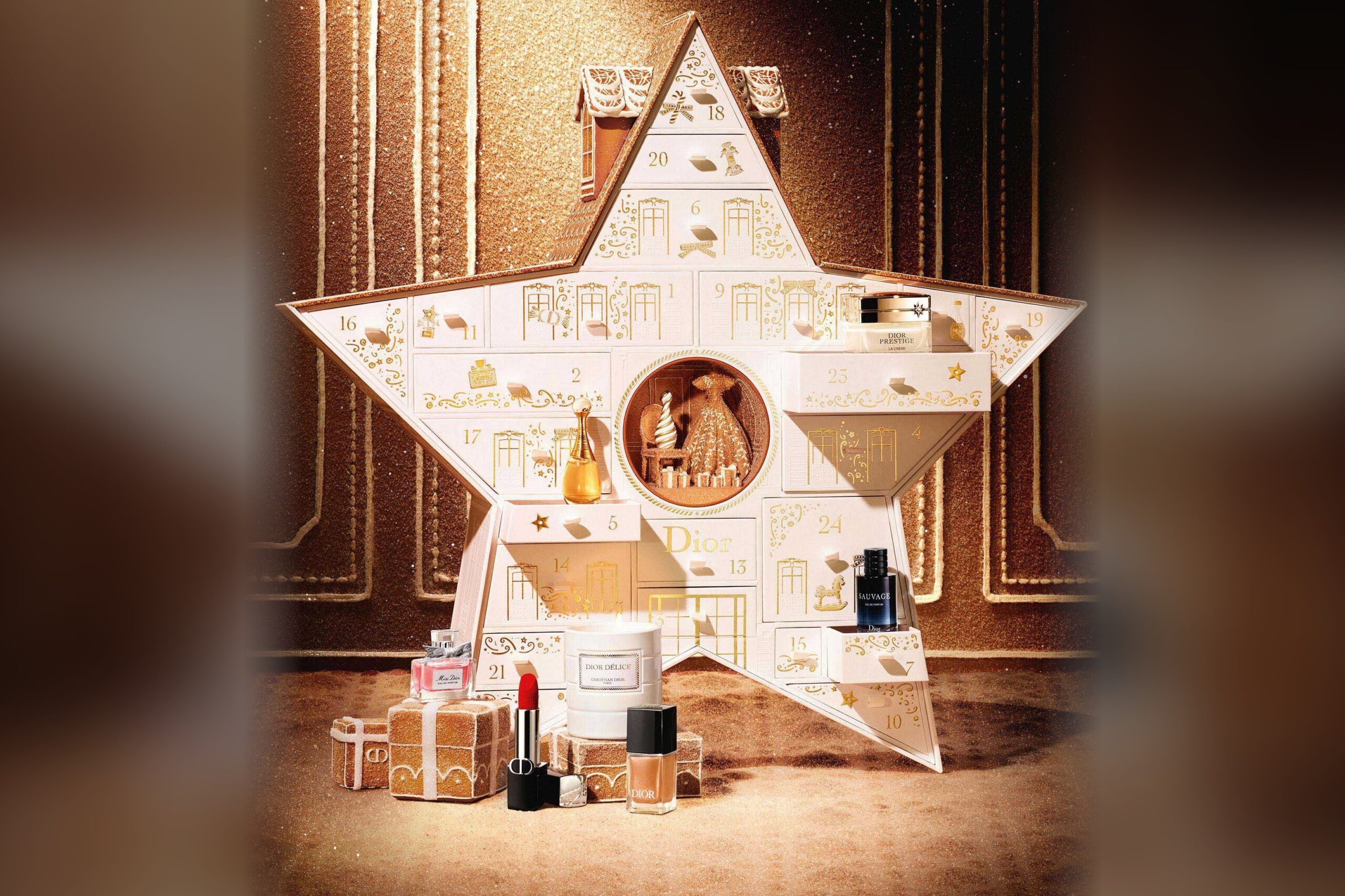 The Dior Le 30 Montaigne advent calendar 2026 open, a white star with numbered doors, with Dior lipstick, perfumes, nail polish and a candle arranged in front