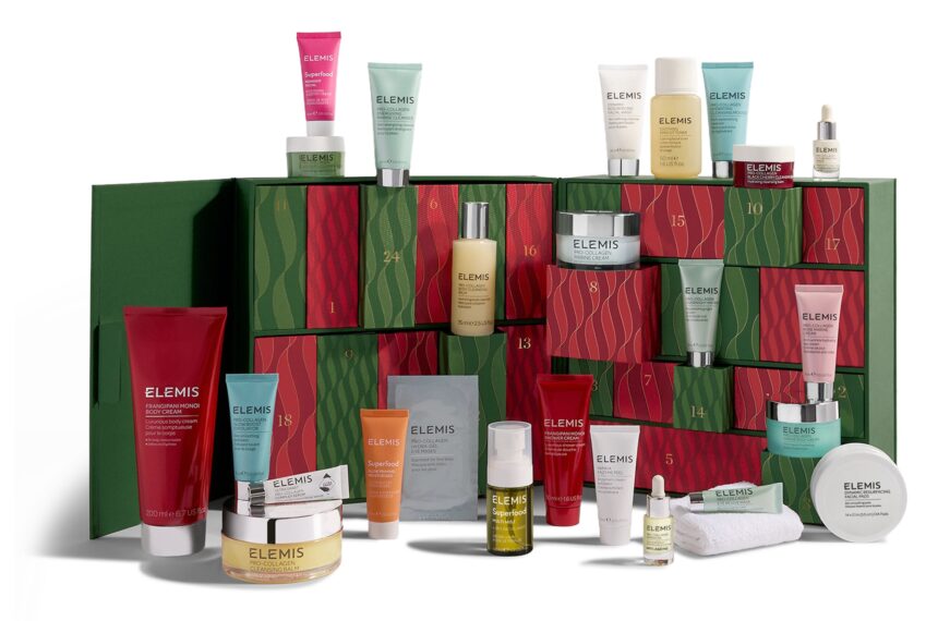 The Elemis Ultimate Beauty Advent Calendar 2026 open, with its green and red drawers and the skincare and body products arranged in front of and on top of it