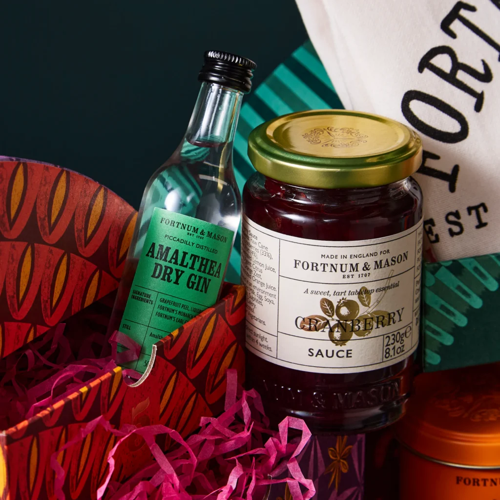 Close-up of an Amalthea gin miniature and a jar of Fortnum’s cranberry sauce from the Feasting Advent Calendar 2026.