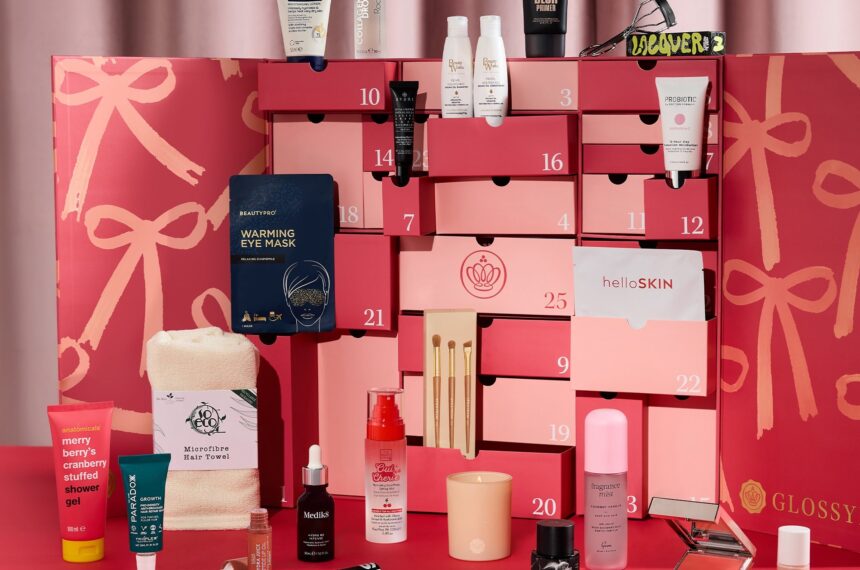 Glossybox Advent Calendar 2026, open with pink drawers and all 26 beauty products displayed around it