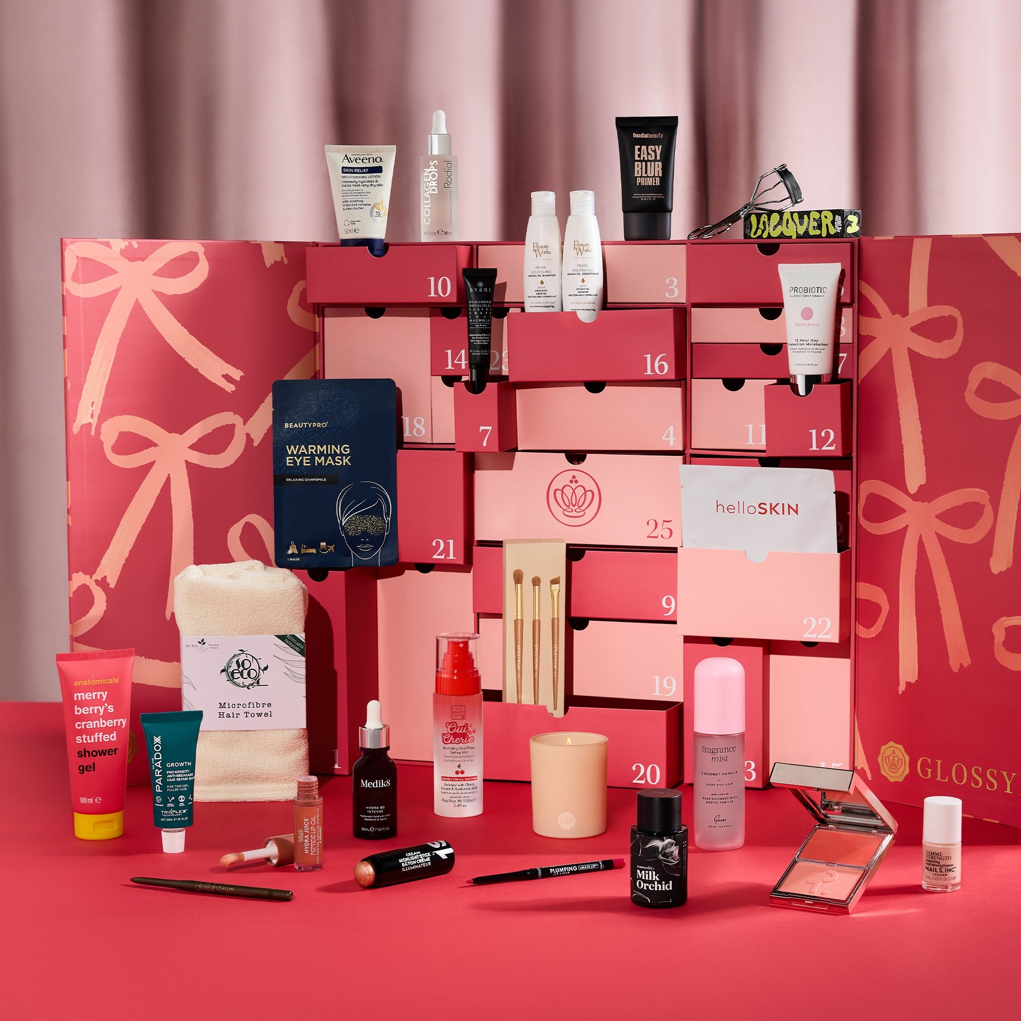 Glossybox Advent Calendar 2026, open with pink drawers and all 26 beauty products displayed around it