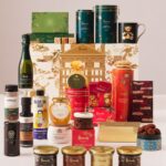 Harrods Food Halls Advent Calendar 2026 with all 25 items arranged around the gold Harrods building calendar box