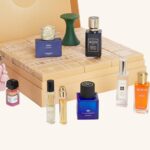 The Harrods Fragrance Advent Calendar 2026 open, with its gold drawers and the 12 fragrances arranged around it