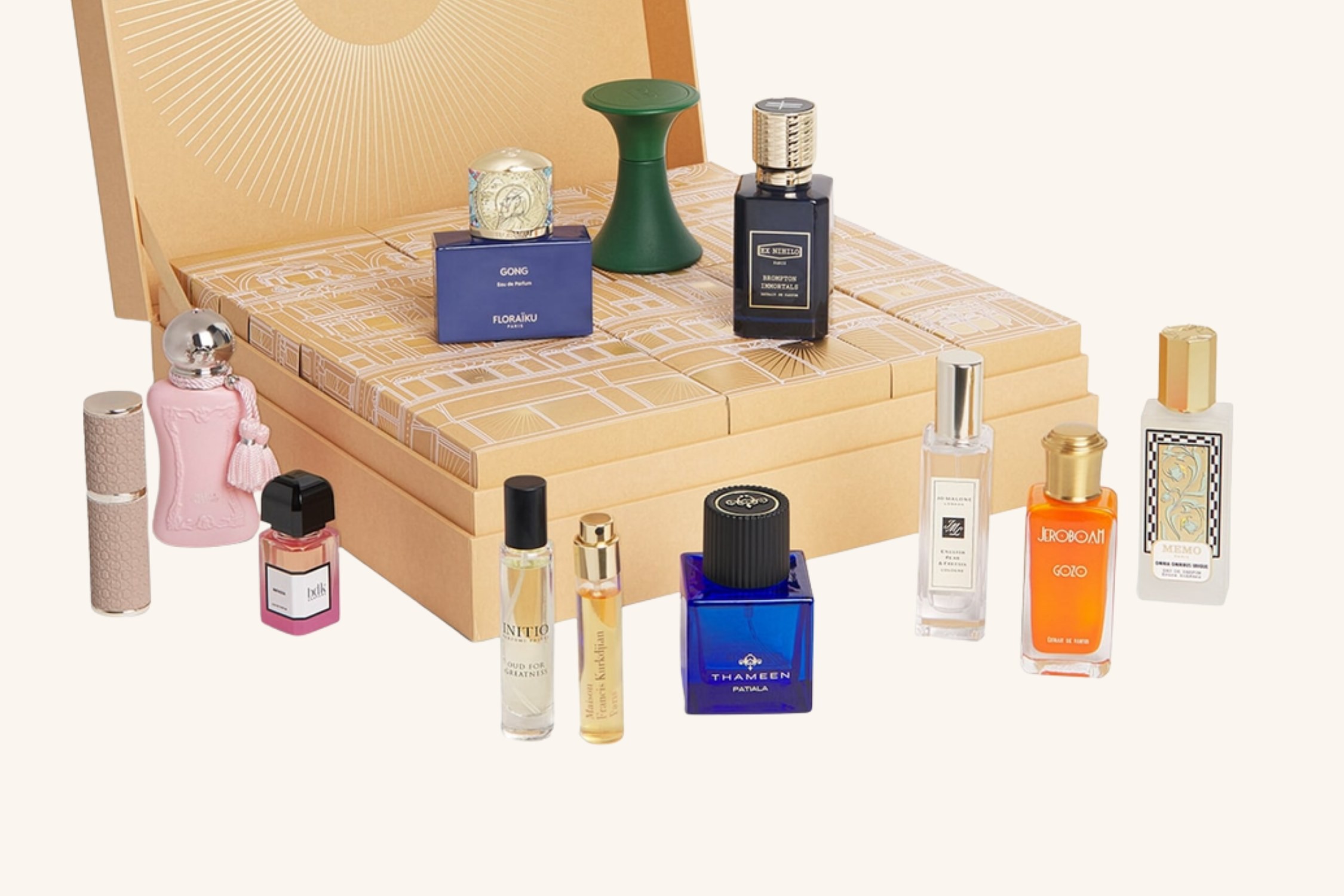 The Harrods Fragrance Advent Calendar 2026 open, with its gold drawers and the 12 fragrances arranged around it