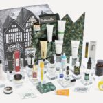 The Liberty Men's Advent Calendar 2026 box, illustrated with the Liberty building, with its grooming, skincare and fragrance contents arranged in front