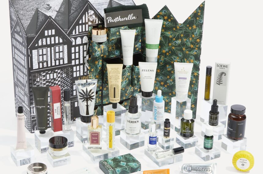 The Liberty Men's Advent Calendar 2026 box, illustrated with the Liberty building, with its grooming, skincare and fragrance contents arranged in front