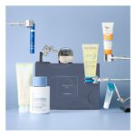 The LOOKFANTASTIC Dermatological Edit box on a blue backdrop with its seven products around it, including a Perricone MD moisturiser, a Eucerin sun cream, a Bioderma shower oil and an Augustinus Bader cream