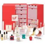The Lookfantastic Fragrance Advent Calendar 2026, a red drawer calendar, with its fragrance minis, candle and atomiser arranged in front