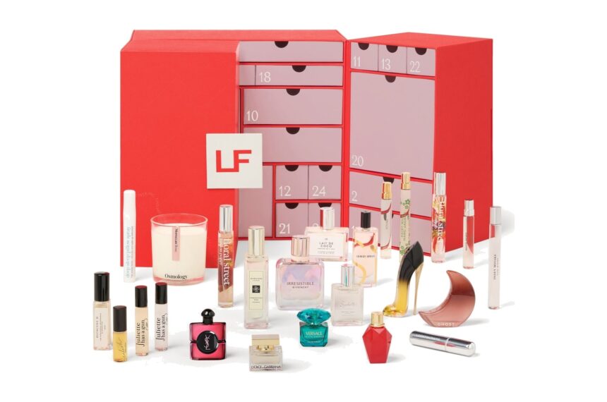 The Lookfantastic Fragrance Advent Calendar 2026, a red drawer calendar, with its fragrance minis, candle and atomiser arranged in front