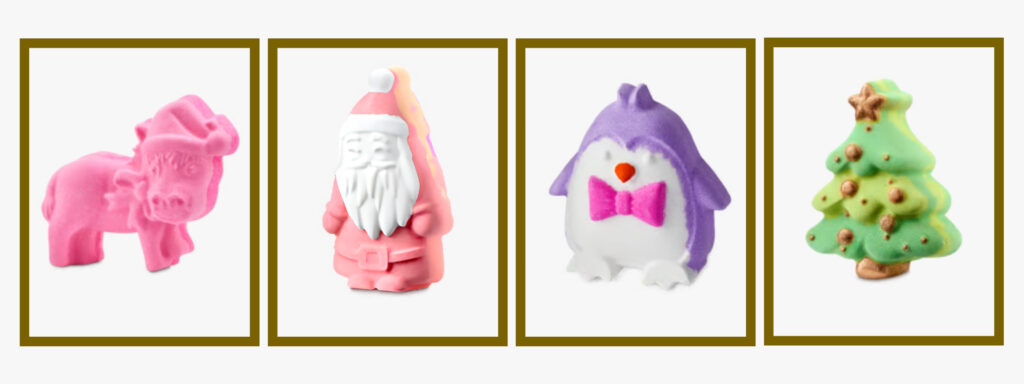 Four character bath bombs from the Lush 29½ High Street Advent Calendar 2026: a pink donkey, a Santa figure, a penguin with a pink bow tie and a green Christmas tree
