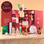 The OK! Beauty Box Advent Calendar 2026 open, with its 25 makeup and skincare products displayed in front of the red calendar