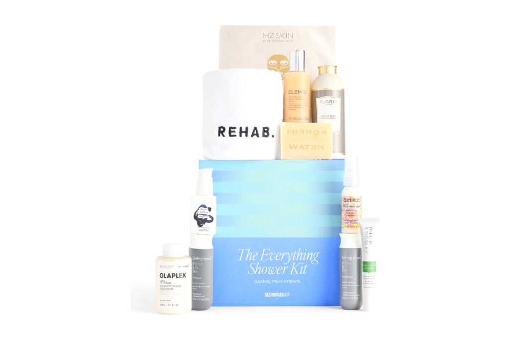 The Selfridges Everything Shower Kit box with its eleven hair, body and skincare products arranged around it