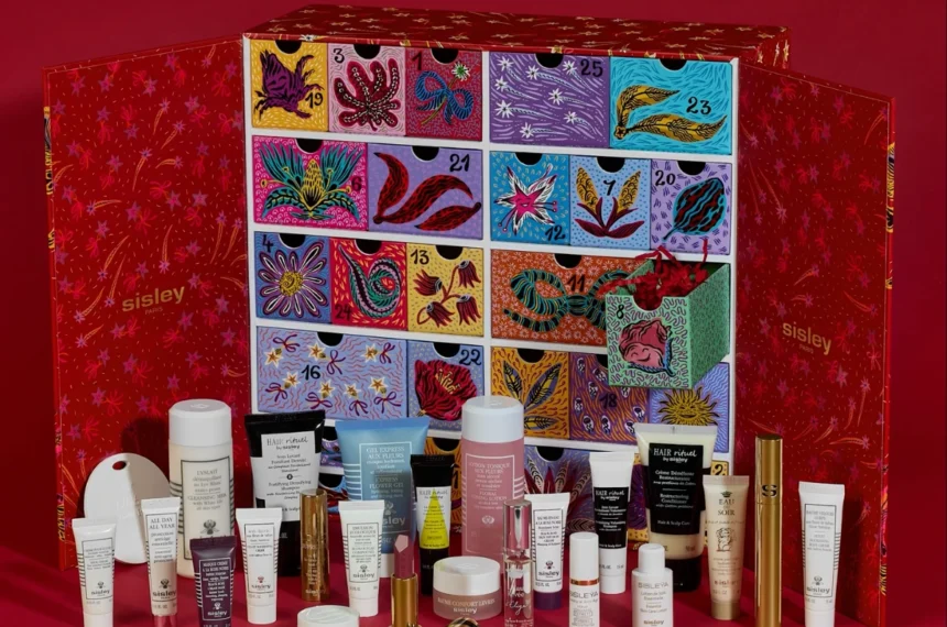 The Sisley Marie-Victoire de Bascher Advent Calendar 2026 open, showing its illustrated drawers with the full product line-up in front