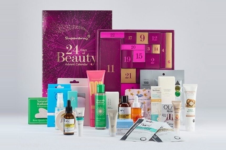 Superdrug 24 Days of Beauty Advent Calendar 2026, open with its numbered pink and plum doors, and the skincare products laid out in front
