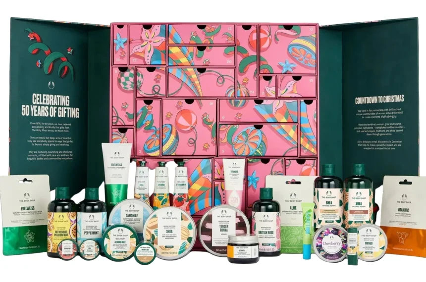 The Body Shop Ultimate Beauty Advent Calendar 2026 drawer calendar open with all 25 products including full-size Shea body butter, shampoo and conditioner arranged in front