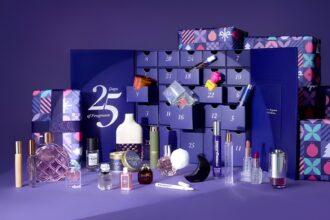 The Fragrance Shop Women's Advent Calendar 2026 open, with its fragrances, candles and extras displayed in front