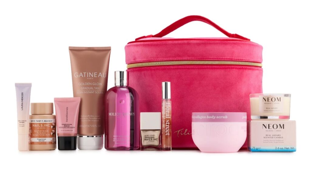 Tili Luxe Beauty Edit 2026 contents lined up beside the pink velvet vanity case, including Molton Brown, NEOM, Gatineau and Laura Mercier