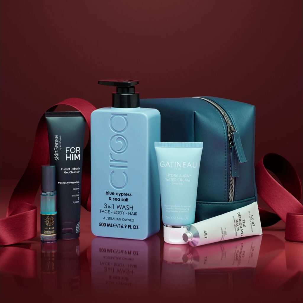 The Tili Luxe Grooming Edit 2026 men's gift set styled with a red ribbon and the navy wash bag
