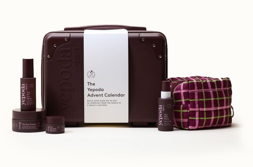 The Yepoda Advent Calendar 2026 plum suitcase with its skincare bottles, jars and checked pouch arranged around it