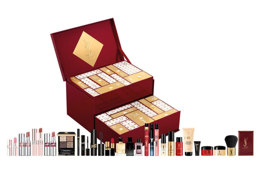 The YSL Beauty Holiday Advent Calendar 2026 open to show its two gold-doored drawers, with its lipsticks, mascaras, fragrances and skincare lined up in front