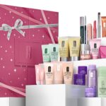 The 24 Days of Clinique Favourites Advent Calendar 2026 in its berry-pink box, with its skincare and makeup lined up beside it