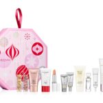 The pink octagonal Elizabeth Arden advent calendar 2026 with its 12 products lined up in front, including Eight Hour Cream, PREVAGE serums and Grand Entrance Mascara