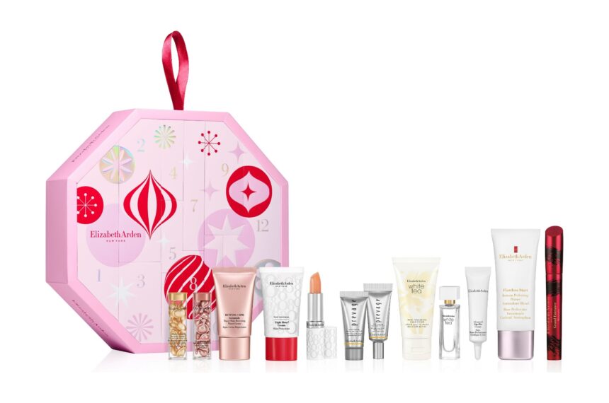 The pink octagonal Elizabeth Arden advent calendar 2026 with its 12 products lined up in front, including Eight Hour Cream, PREVAGE serums and Grand Entrance Mascara
