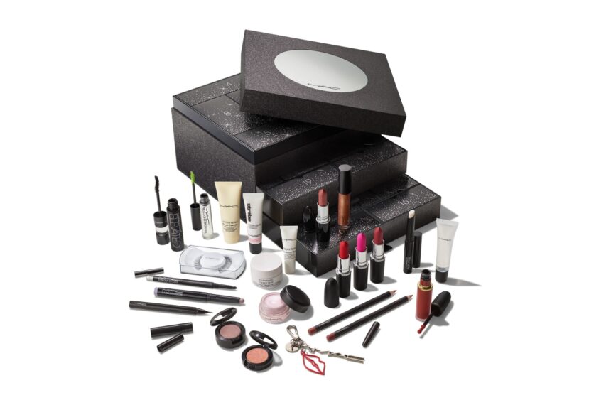 The 24 Days of M·A·C Icons Advent Calendar 2026, a black glittering box of stacked drawers with a mirrored lid, with its lipsticks, lip pencils, mascaras, eyeshadows, lashes and skincare minis set out in front