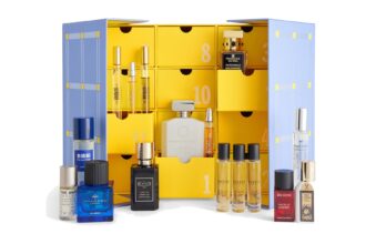The Selfridges Fragrance Advent Calendar 2026 open, with the niche perfumes displayed in front of the yellow and lilac cabinet