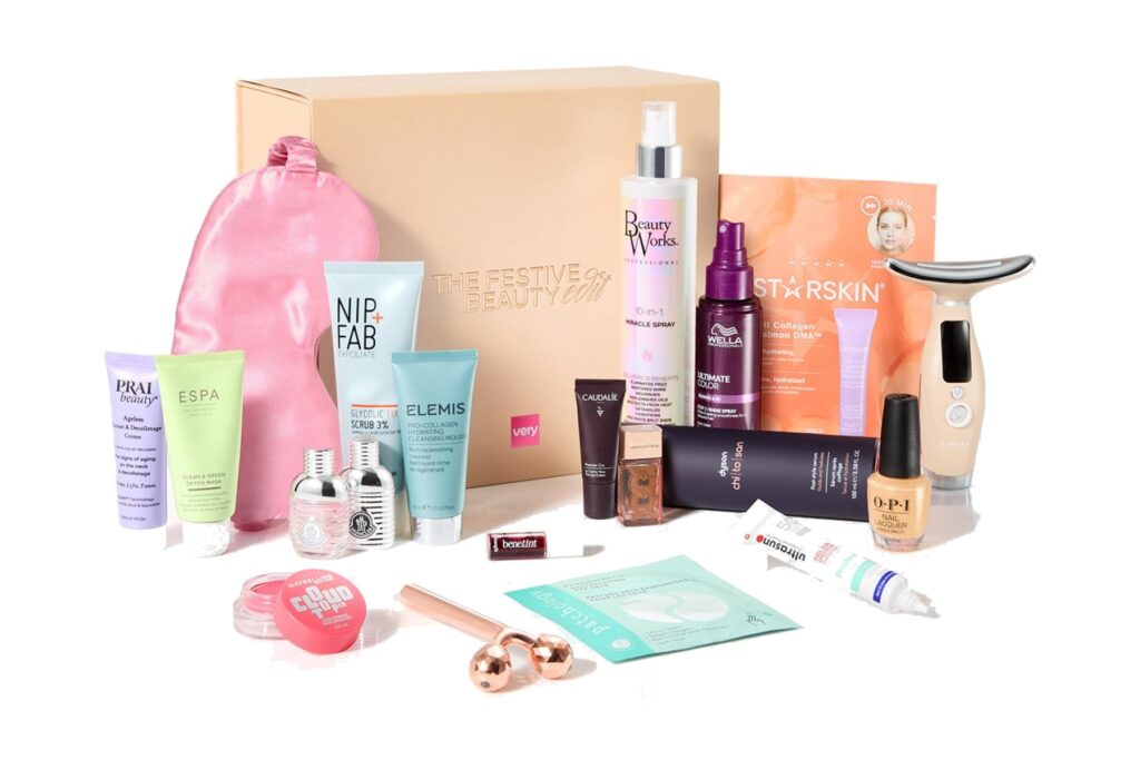 The Very Festive Beauty Box 2026 with its products set out in front of the box